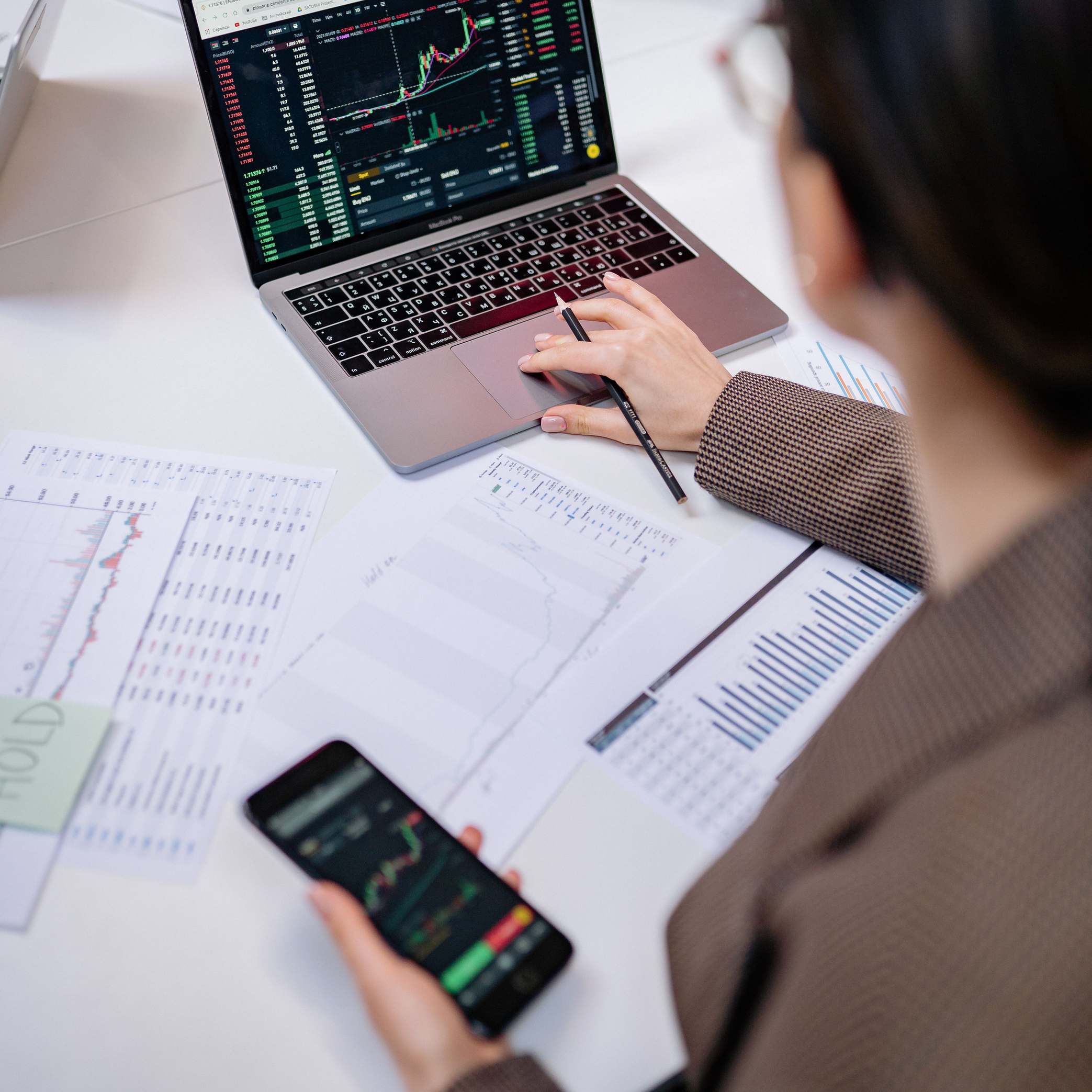 Overhead view of a laptop showing market charts